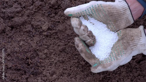 New Technology in agribusiness. Potassium nitrogen fertilizers in protected hands. Top view control soil quality seed plant. Smart farming, using modern enrichment. Future agriculture concept. 2026 4K