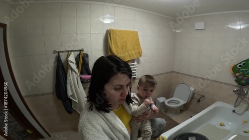 Mother and Child Brushing Teeth Together