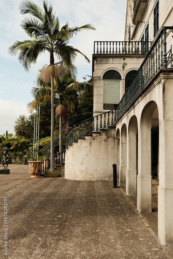 Obraz premium Calm waterside path featuring weathered walls and shaded seating