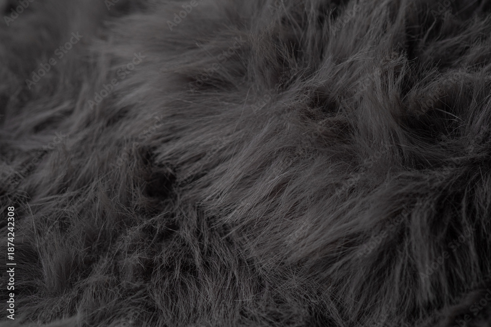 Obraz premium Detailed textured background showing a close up of luxurious soft dark grey artificial fur fabric