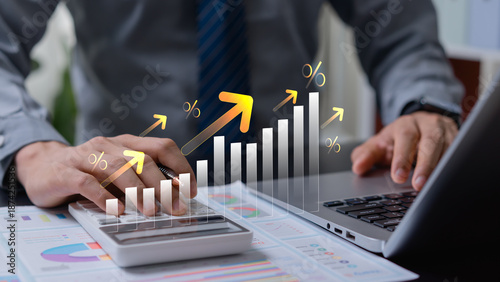 Businessman calculating financial interest with growth arrow, money and business investment analysis, profit increase, revenue planning and economic success concept.
