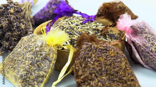 Dried lavender organza sachets filled with petals and buds lie on a table, side view