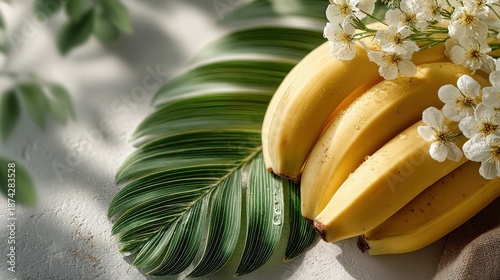 Fresh Bananas with Green Leaf and White Flowers on Soft Background