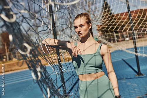 Young blonde sportswoman enjoys an outdoor workout during a sunny spring day