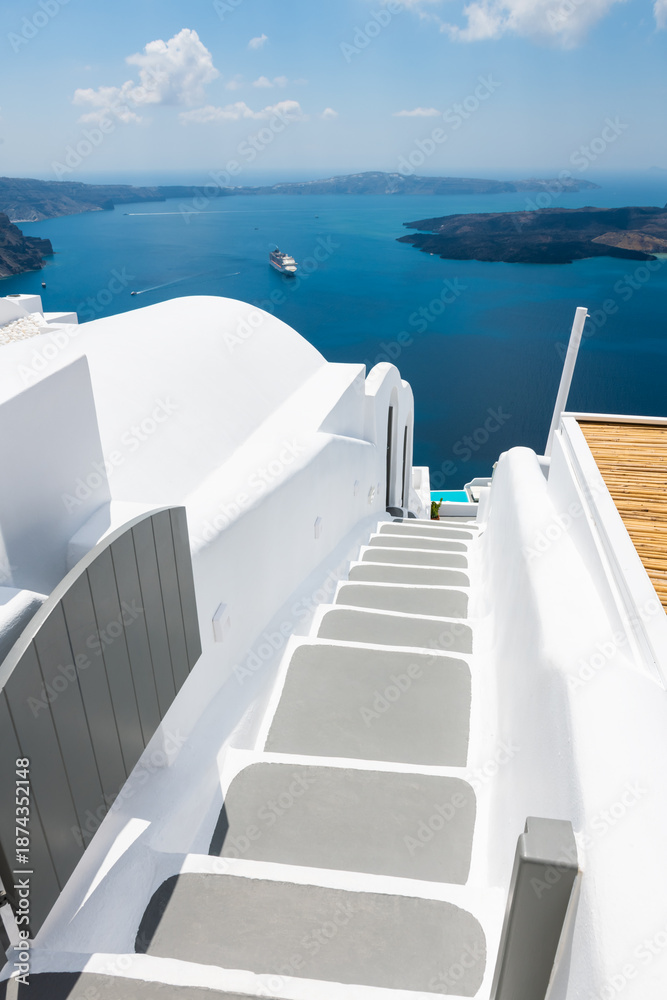 Fototapeta premium White architecture in Santorini island, Greece. Stairs to the sea. Beautiful seascape at sunny day.