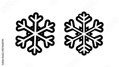 Pair of decorative snowflake icons with intricate symmetrical designs for winter holiday and festive season themes.