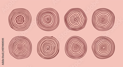 An artistic collection of tree rings depicted as circular patterns on a subtle pink background creating a natural abstract visualization of time and