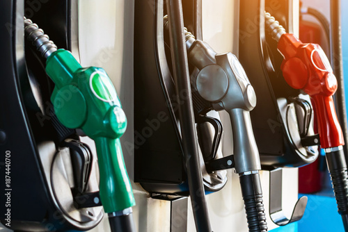 Petrol fuel nozzle for fuelling in petrol fuel station. Hand refilling car with fuel at gas station. Nozzle pump petroleum fuel. Fuel dispensing pump. Fuel and Business service energy concept.