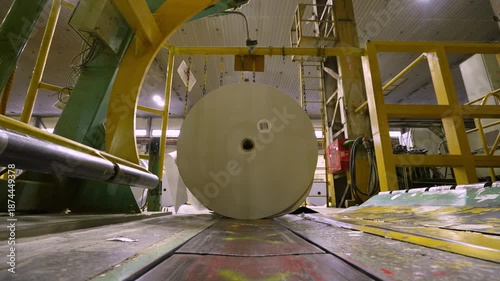 Paper rolls are fed into packaging using an automatic line. Paper production