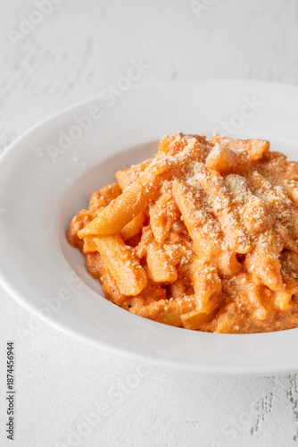 Penne pasta in creamy ricotta tomato sauce with grated parmesan cheese
