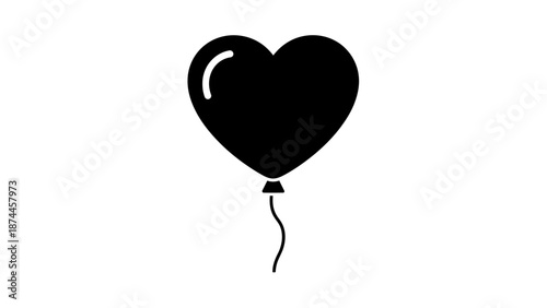 Black heart shaped balloon with string floating gracefully.
