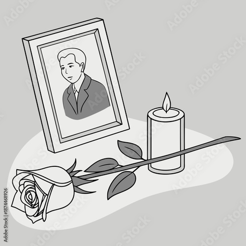 Grayscale of memorial with framed portrait candle and rose