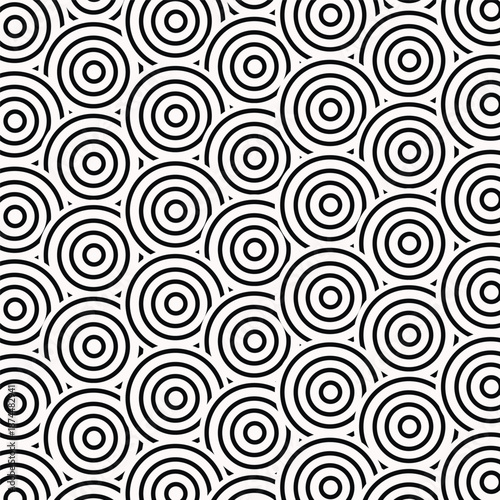 A black and white geometric pattern with repeating concentric circles evenly spaced across the surface.