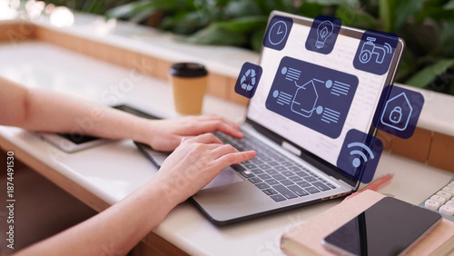 Foto Person using laptop manage smart home application with central control panel for