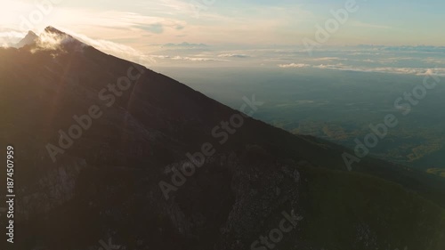 4K drone footage of Mount Raung at sunrise, revealing steep ridges, misty forests, and one of Indonesia’s most extreme hiking trails with cloud and vulcano 