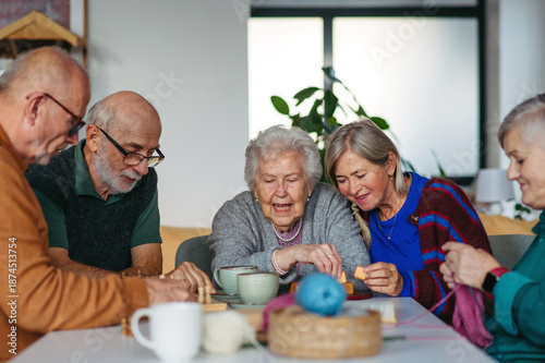 Konstfotografi Group of senior people enjoying different activities in community center