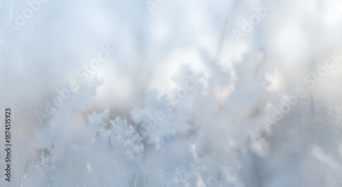 Detailed view of a frosted window pane covered in intricate ice patterns for a serene winter background concept and cold season aesthetic.