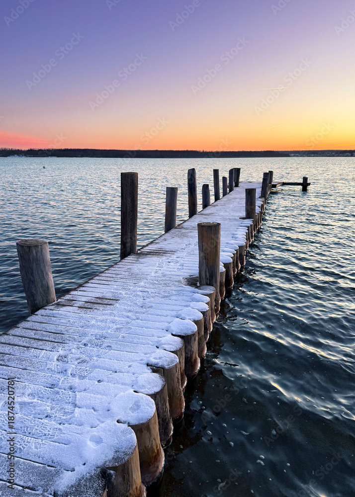 Fototapeta premium long wooden pier at sunset in winter season 