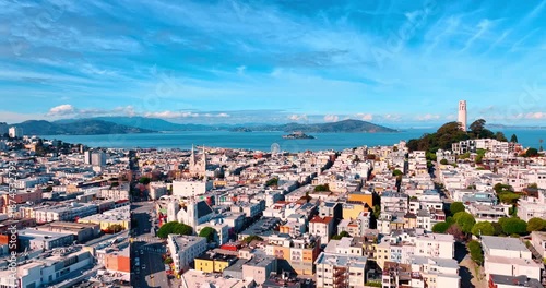 Amazing city scenery of San Francisco, California, United States. View on Coit Tower at the Telegraph Hill. Beautiful blue bay waterscape at backdrop.