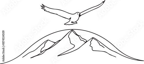 Bird soaring over majestic mountain peaks in flight