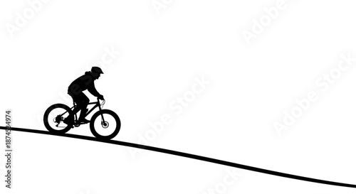 Silhouette of a Mountain Biker Riding on a Rugged Trail at Sunset