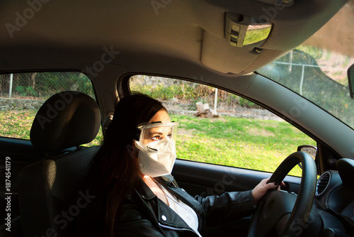 Caucasian woman driving vehicle with coffee cup in hand at sunset in Mexico smiling