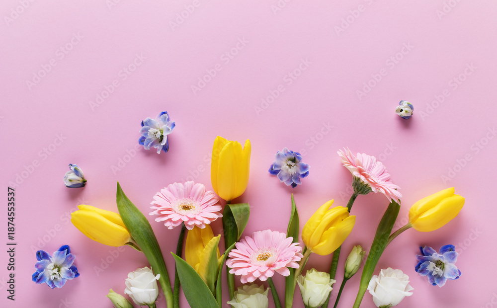 Fototapeta premium Beautiful banner with spring flowers on pastel pink table top view. Greeting card for International Women Day or Mother day. Flat lay.