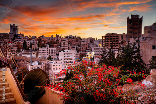 Tableau sur toile Colorful sunset sky in Amman, capital of Jordan, with traditional residential buildings on hills, Middle Eastern architecture