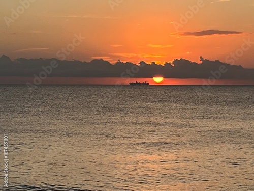 Sunset on a beach, with an orange colour. Very beautiful summer panorama. Golden hour.