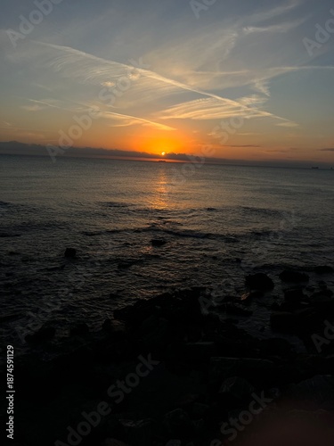 Sunset on a beach, with an orange colour. Very beautiful summer panorama. Golden hour.