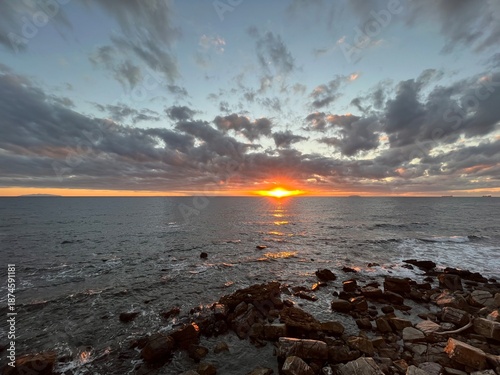 Sunset on a beach, with an orange colour. Very beautiful summer panorama. Golden hour.