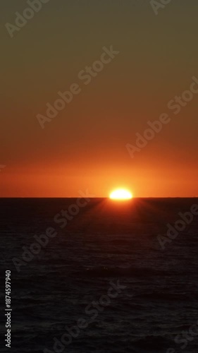 Sun at sunset in the sea. 4K Vertical