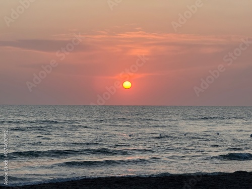 Sunset on a beach, with an orange colour. Very beautiful summer panorama. Golden hour.