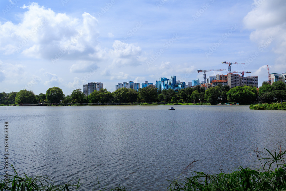 Fototapeta premium Panorama view of Jurong Lake with apartment towers of Taman Jurong Estate and cranes, Singapore