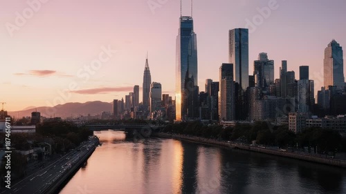 Cityscape with modern skyscrapers and river at sunset