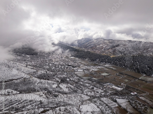 Odemis valley village and fields under winter snow