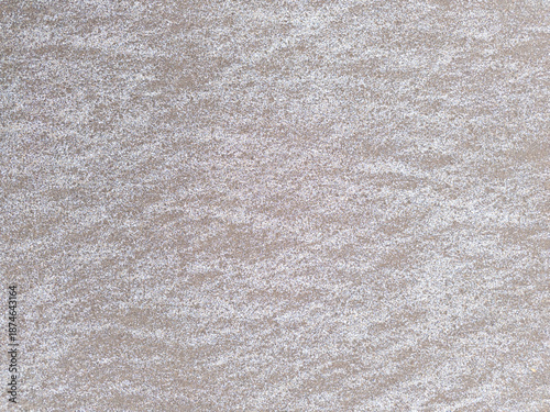 straight white criss-cross lines on flat brown sand surface