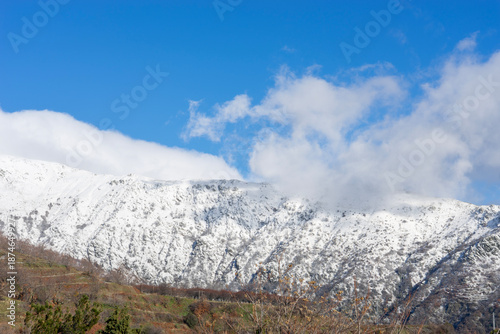 White snow covering mountain peak under blue sky