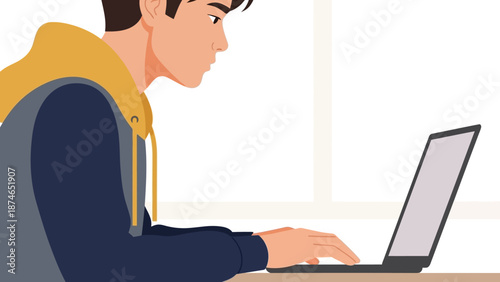 Focused young man using laptop in modern workspace