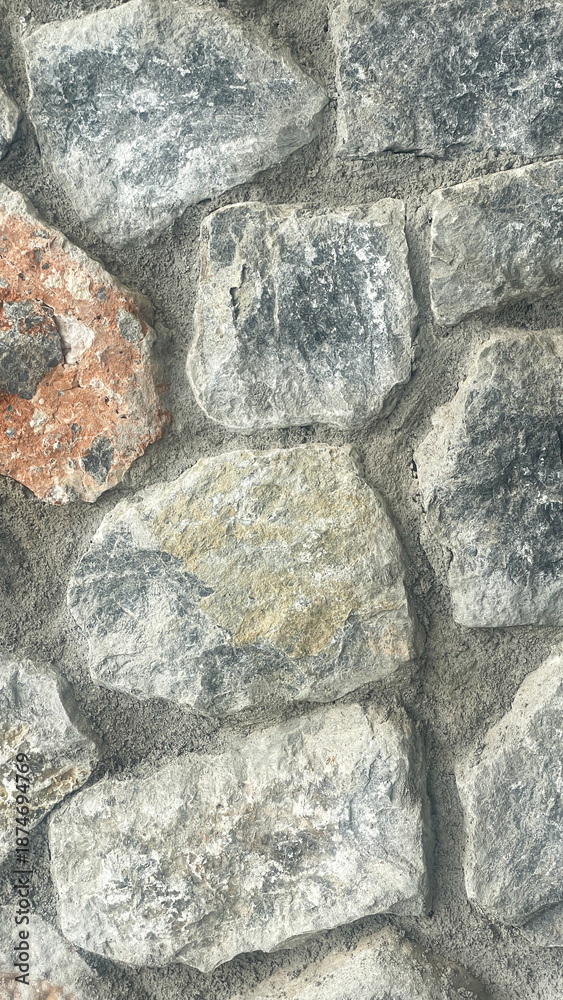 Fototapeta premium Natural Stone Wall Texture With Rough Rocks And Cement Joints, Close Up Of Rustic Masonry Surface For Exterior Or Interior Design, Construction, Architecture And Background Use