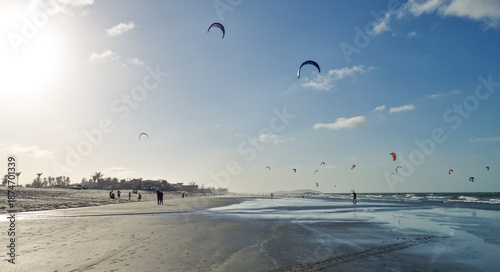 Golden hour at Prea beach with kitesurfers enjoying in the ocean.
