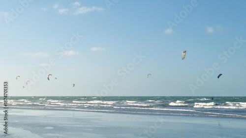 Kitesurfers riding waves at Preá beach, Ceará, long untouched coastline and powerful trade winds ideal for kiteboarding.
