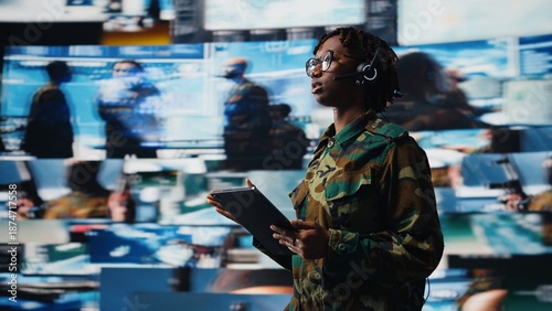 Photos Army operator communicating enemy activity to ground troops using device