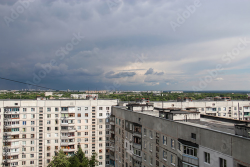 A panoramic urban view of a residential district in Kharkiv, Ukraine, featuring typical multi-story concrete apartment blocks.
