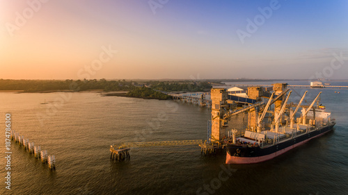 Amazonian Sunrise over soybean bulk carrier at Itupanema port in Barcarena, Amazon, Brazil
