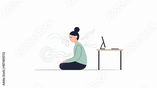 Woman in meditative pose at wooden desk with monitor and keyboard
