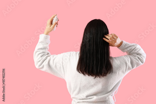 Young woman in bathrobe app...
