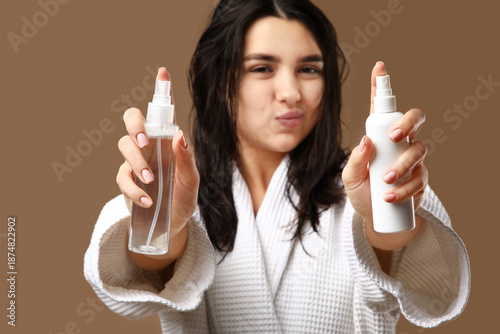 Young woman with hair spray...