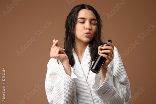 Young woman with hair spray...