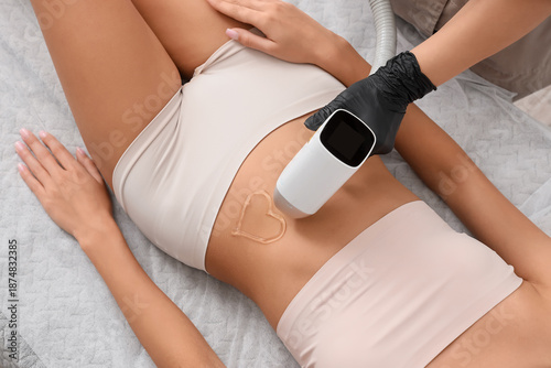 Woman's belly with heart ma...